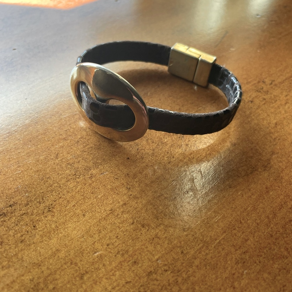Leather and gold tone magnetic close bracelet.
